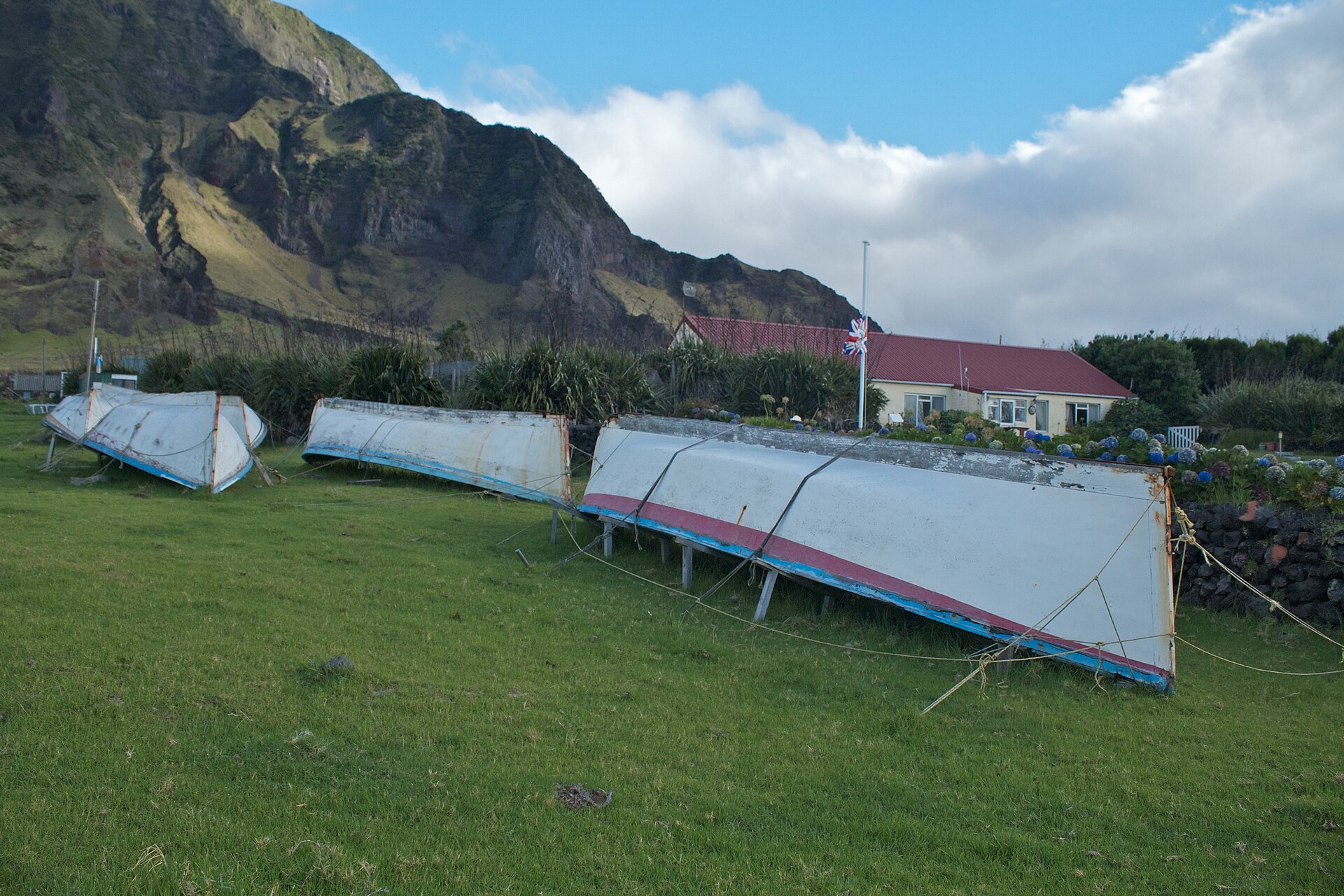 Longboats drawn up on the grass at the Settlement