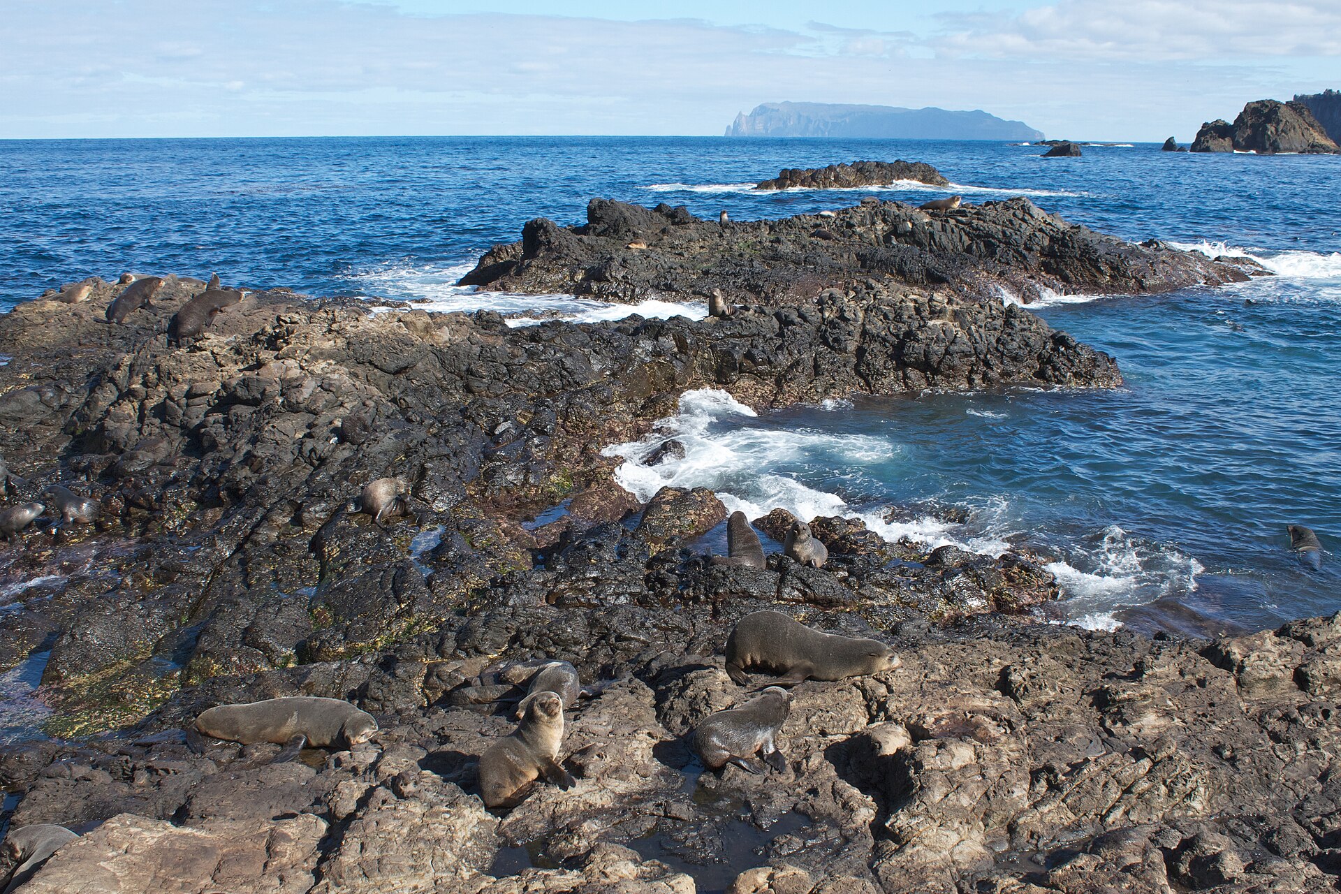 Lava coast with Inaccessible Island on the horizon